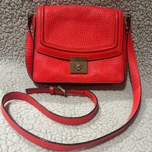 Kate Spade Coral color leather crossbody, adjustable strap.